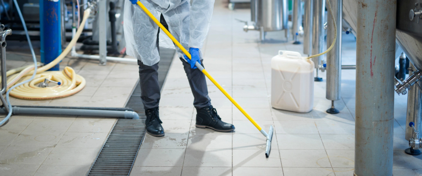 janitor wiping industrial floor clean